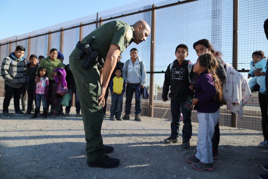 A+group+of+Central+American+migrants+is+questioned+about+their+childrens+health+after+surrendering+to+U.S.+Border+Patrol+Agents+south+of+the+U.S.-Mexico+border+fence+in+El+Paso%2C+Texas%2C+U.S.%2C+March+6%2C+2019.