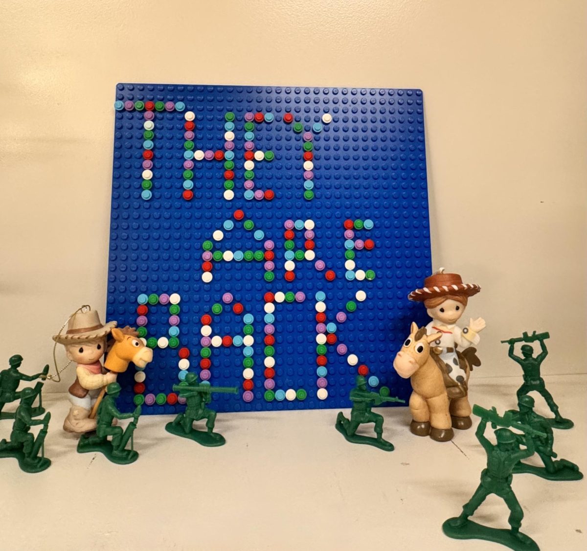 Toy Story characters next to Lego sign